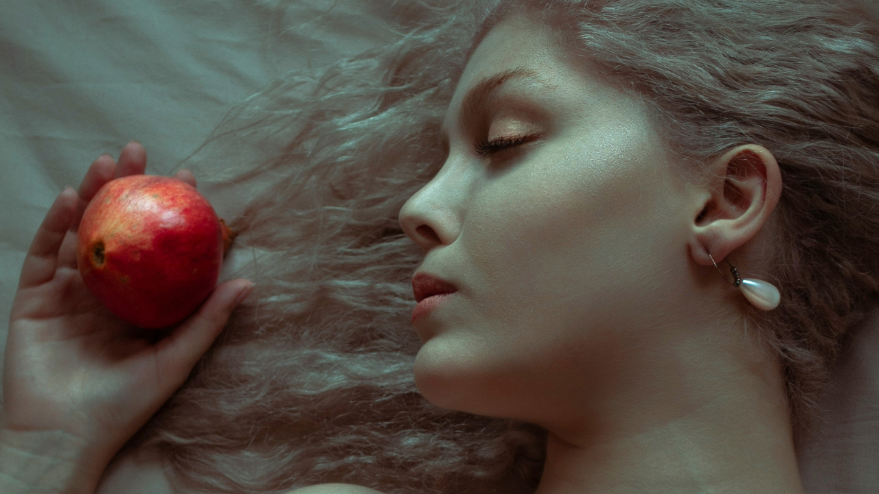Sleeping Beauty Talia beside an apple.