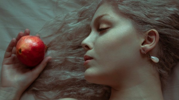 Sleeping Beauty Talia beside an apple.